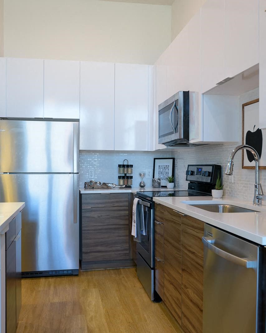 a kitchen with stainless steel appliances and white cabinets