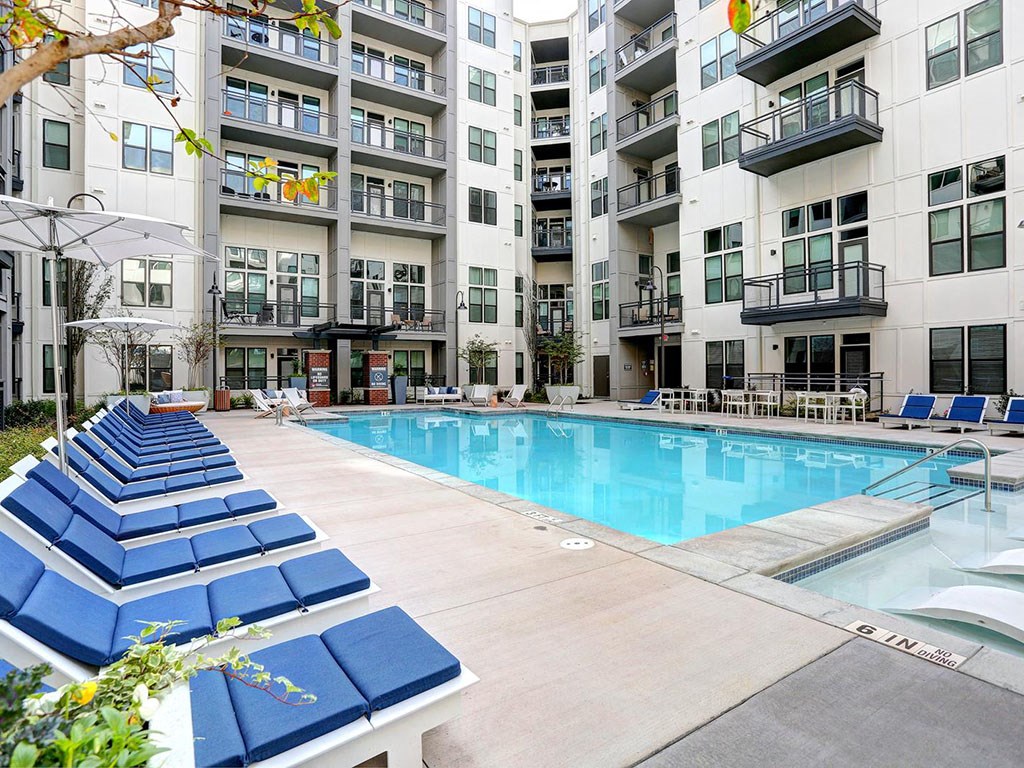 a swimming pool in front of an apartment building