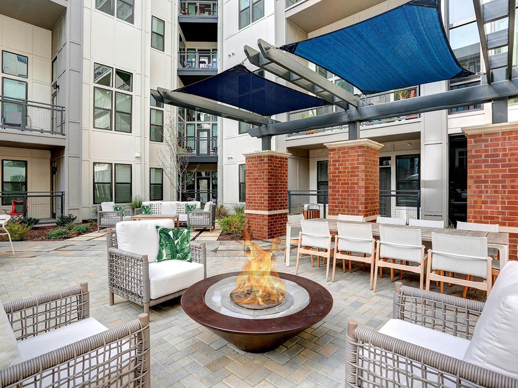 an outdoor seating area with a fire pit