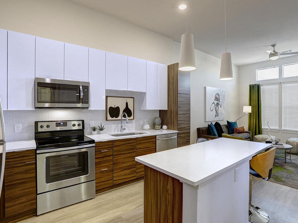 a kitchen with stainless steel appliances and a white counter top