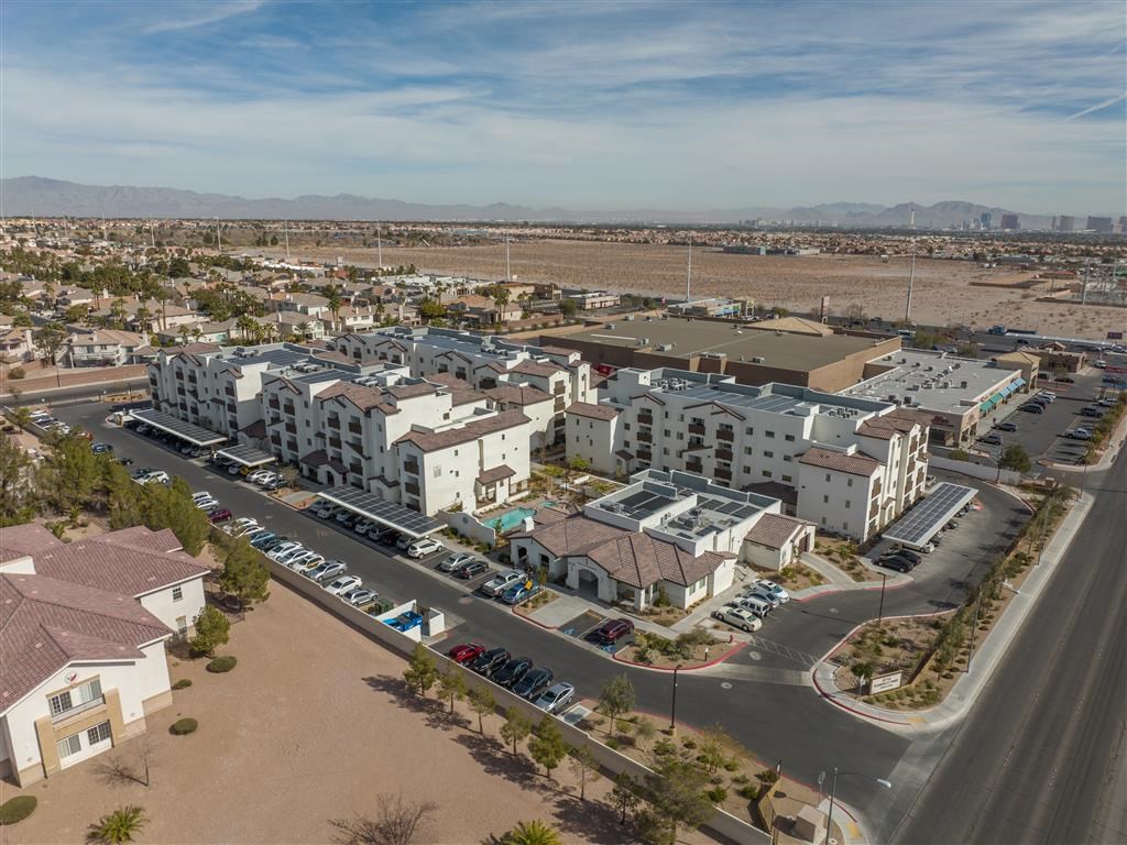 an aerial view of a city with buildings and a parking lot