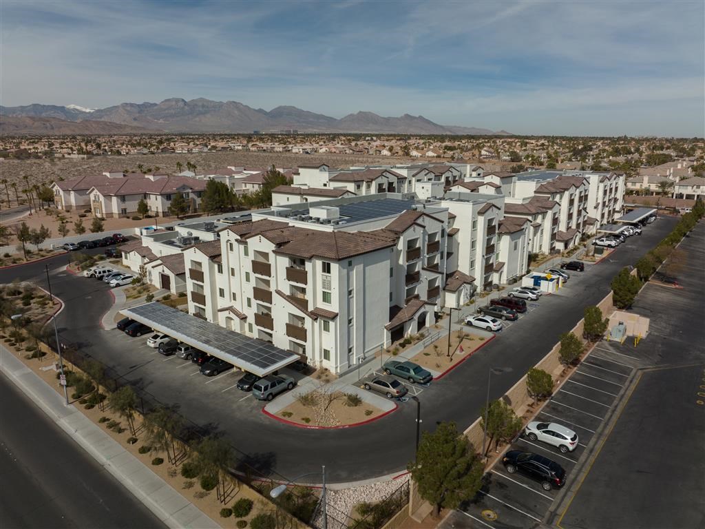 an aerial view of an apartment complex with a parking lot