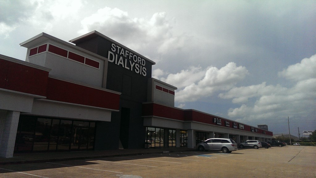 A Stafford Dialysis building with a car parked in front.