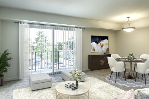 A living room with a white sofa, a round table, and a painting on the wall.