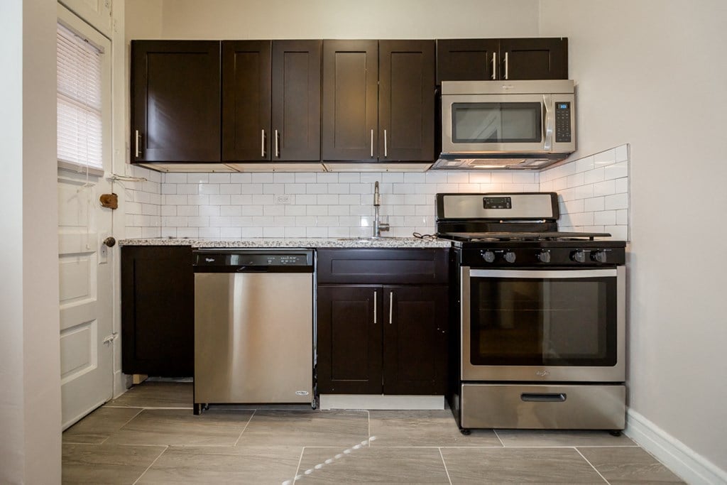 a kitchen with stainless steel appliances and wooden cabinets