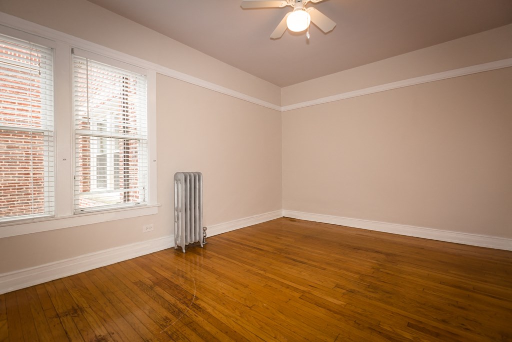 an empty room with a radiator in the middle of it