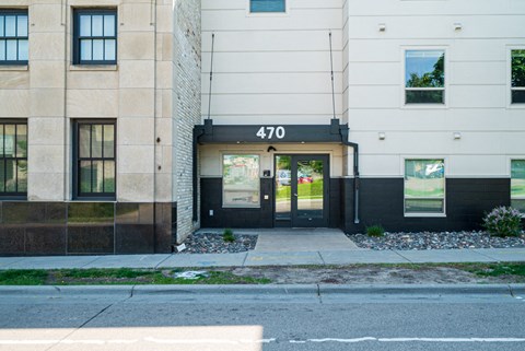 The number 470 is displayed on a black sign above a black door.