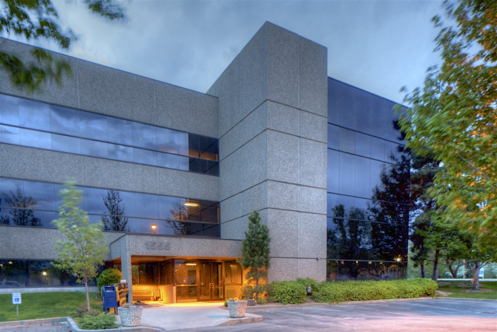 a large building with glass windows at night