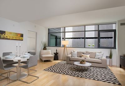 Dining and living area with large windows