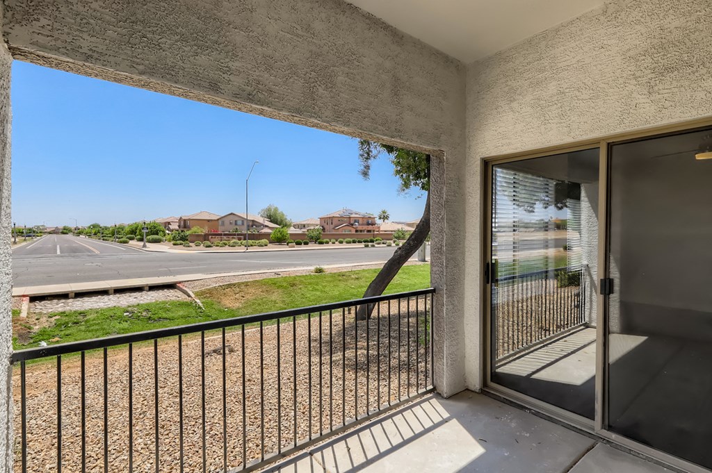 the view from the balcony of a building with a door and a street