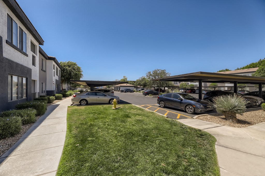 a parking lot with cars parked in front of a building