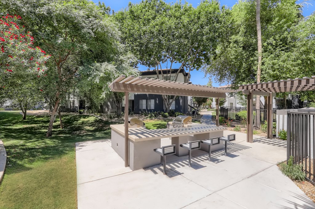 a patio with a table and chairs and a pergola