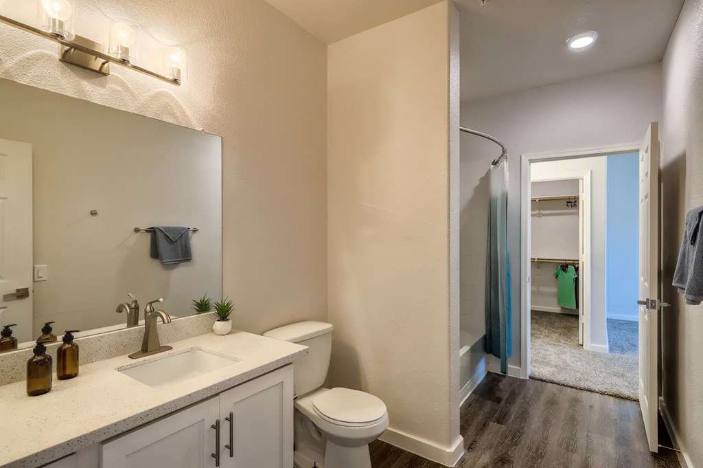 a bathroom with a toilet and a sink and a shower
