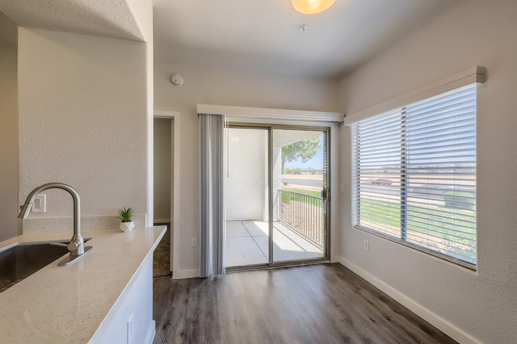 an empty kitchen with a sliding glass door leading to a patio
