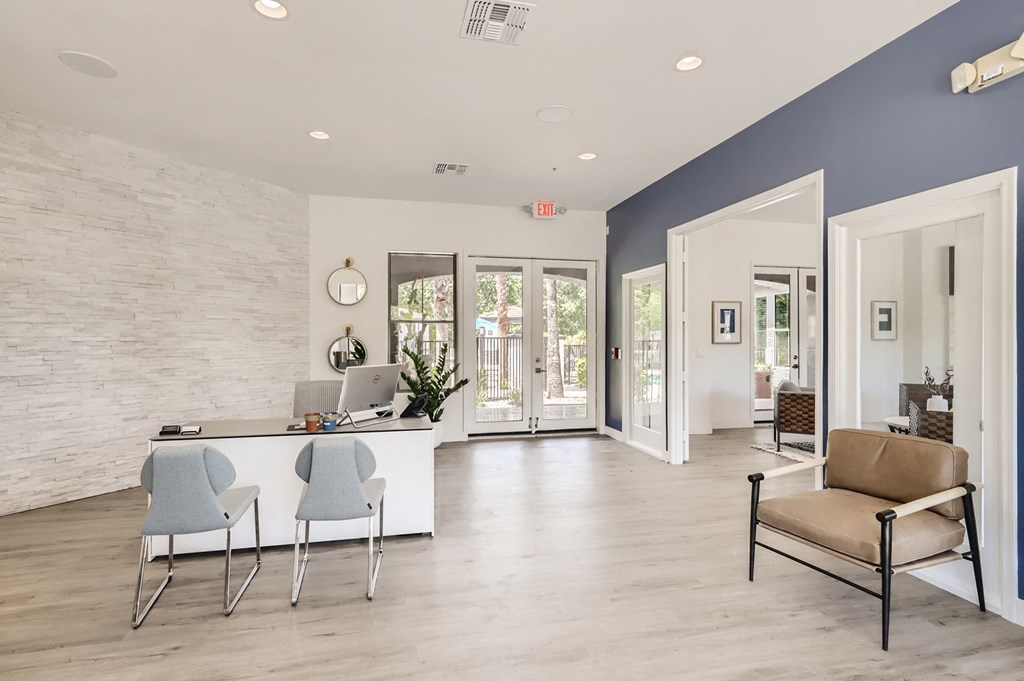 an office with a desk and chairs in front of a door