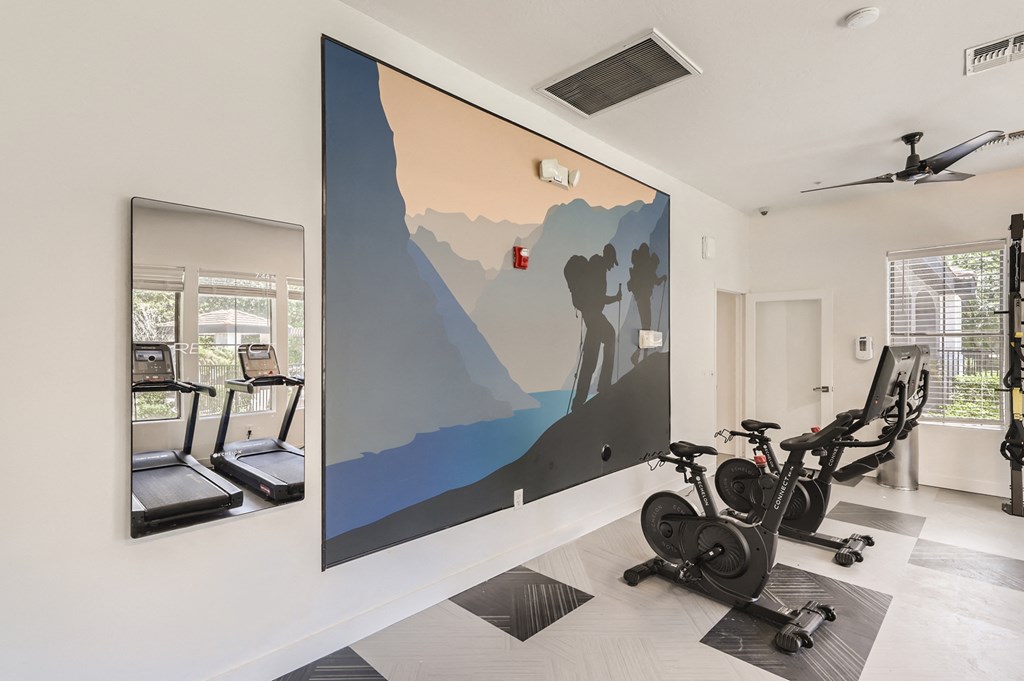 a gym with a large painting of a man climbing a mountain