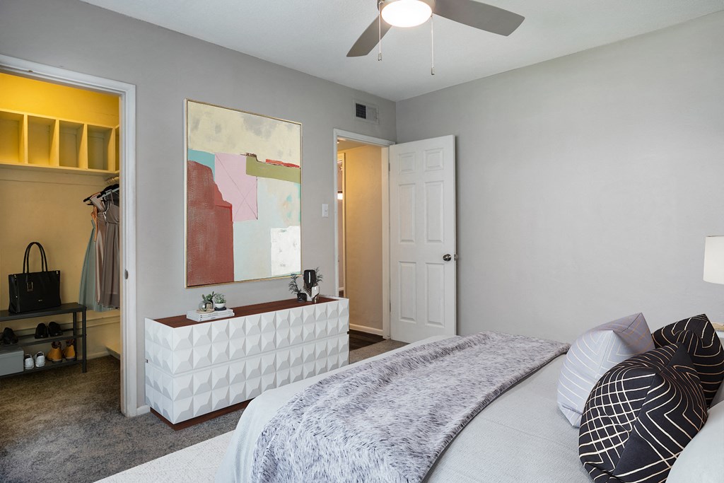 a bedroom with a large bed and a ceiling fan