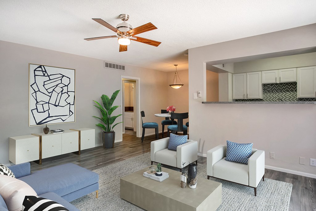 a living room with furniture and a ceiling fan