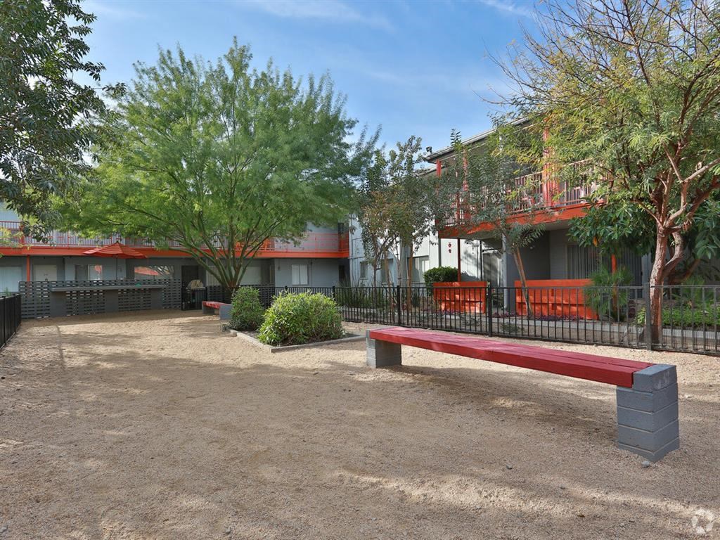 a red bench sitting in front of a building