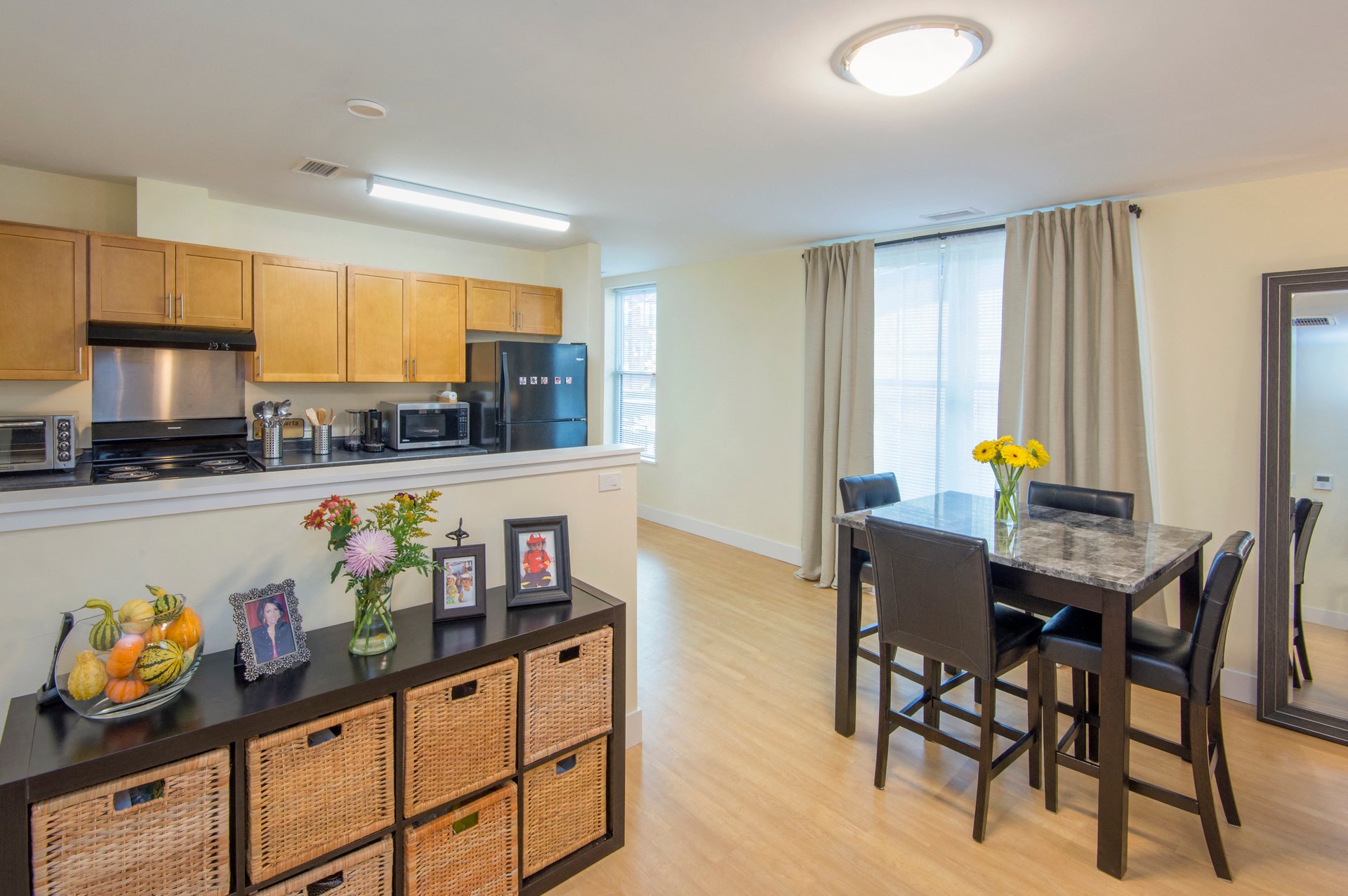 a kitchen and dining room area with a dining table and chairs and a counter top