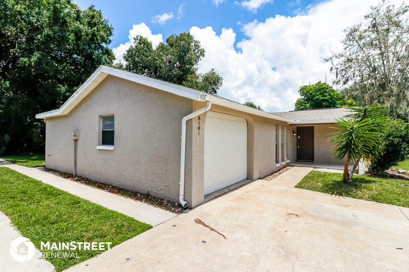 a white house with a driveway and a garage door