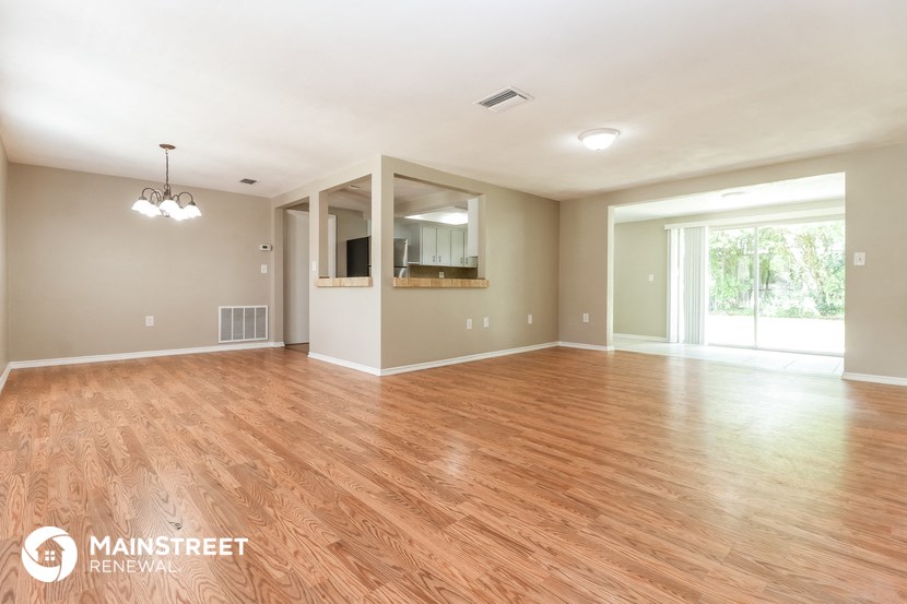 the living room and dining room with wood flooring