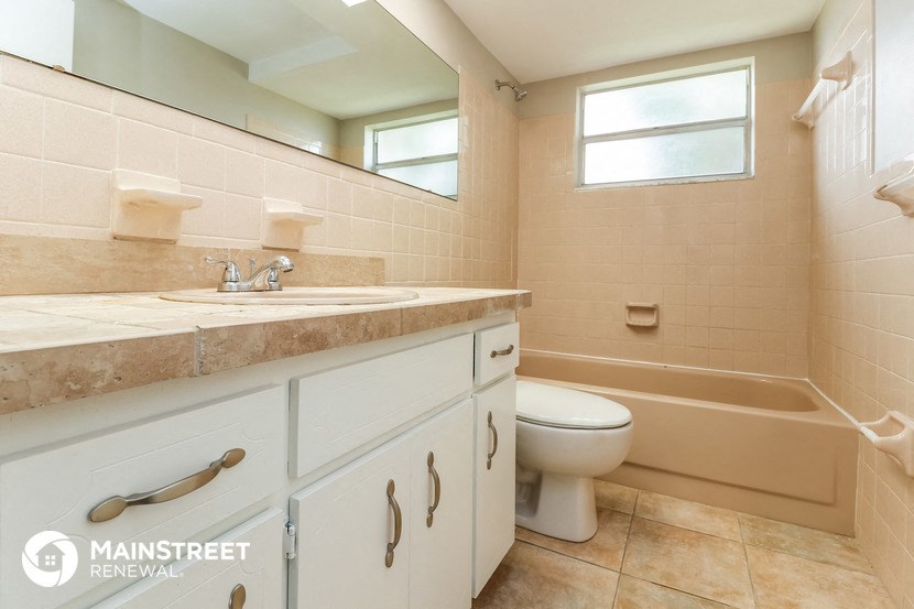 a bathroom with a sink toilet and a bath tub