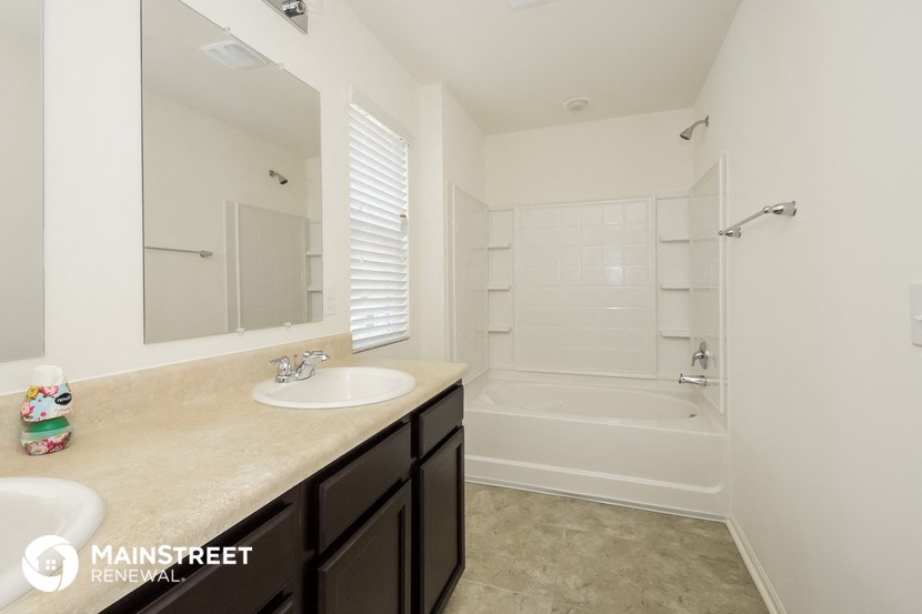 a bathroom with a sink and a shower and a bath tub