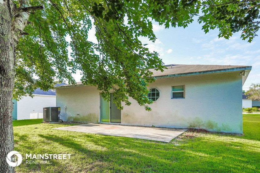 a white house with a tree in front of it