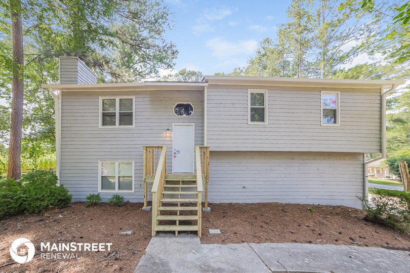 a white house with a white front door and stairs
