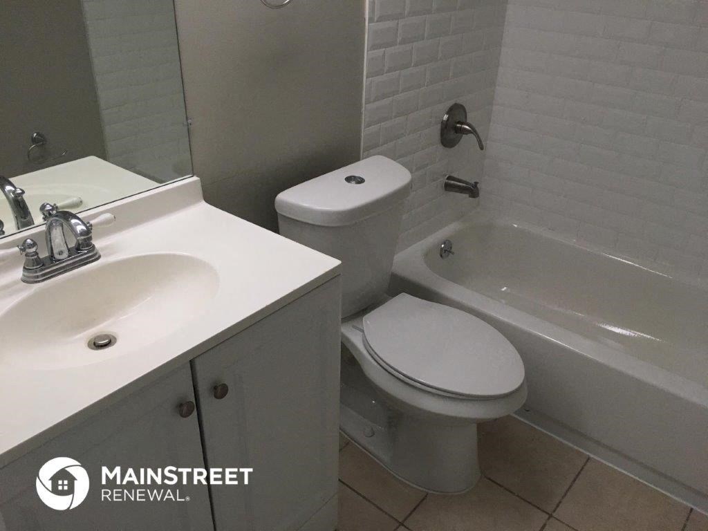 a bathroom with a sink toilet and a bath tub