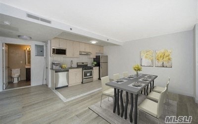 a kitchen and dining room with a table and chairs