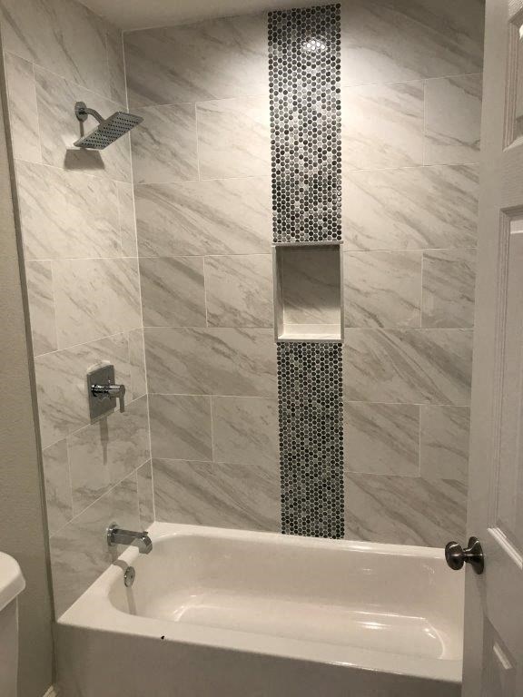 a bathroom with a shower and a bath tub
