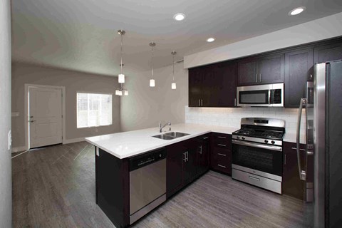 a kitchen with stainless steel appliances and a white counter top