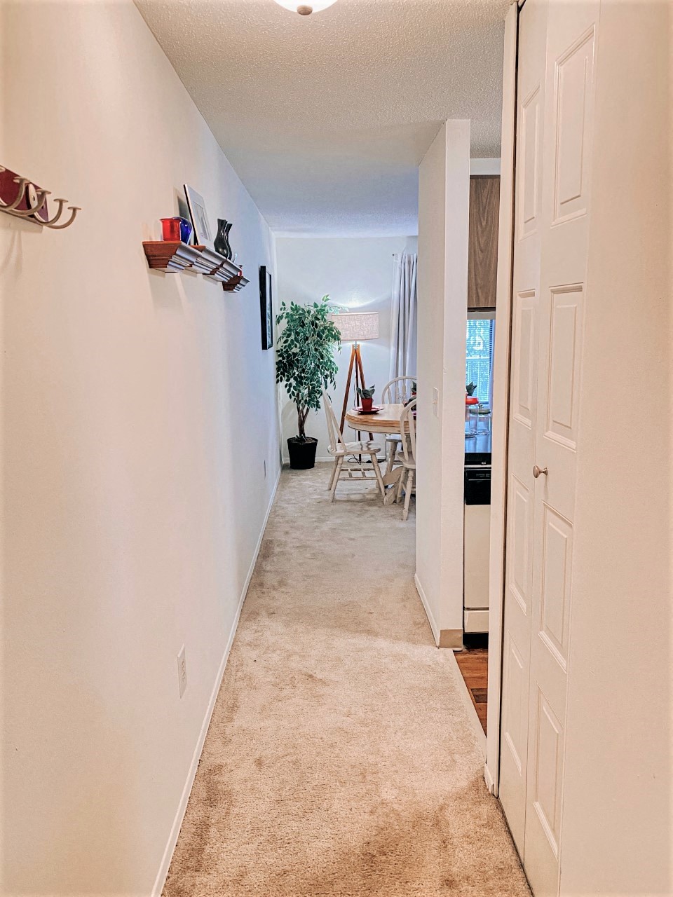 the spacious hallway leading to the dining room and living room