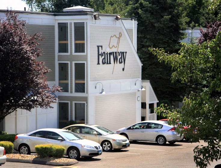 a large building with cars parked in front of it