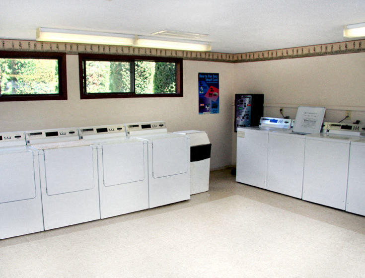 the laundry room is equipped with washers and dryers