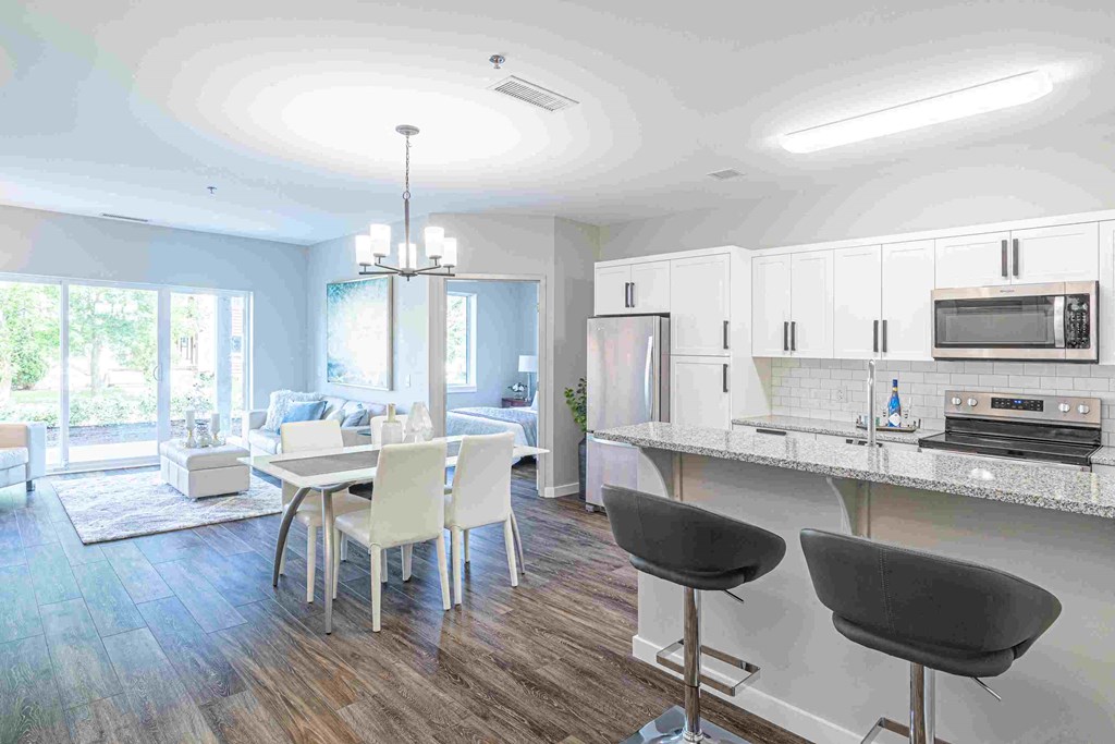 an open kitchen and dining room with a table and chairs