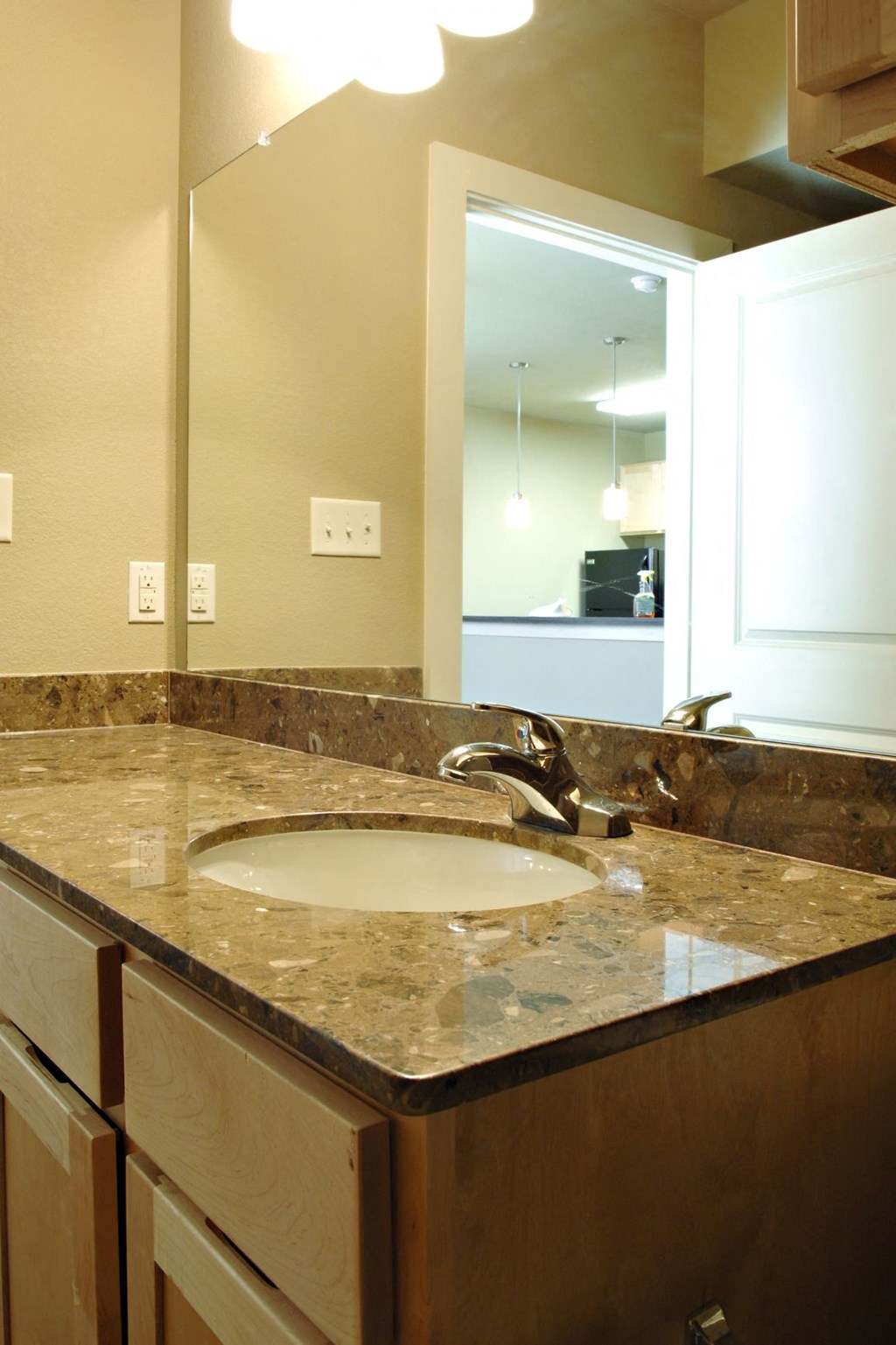 A bathroom with a sink and mirror at Centre Place Apartments, Denton