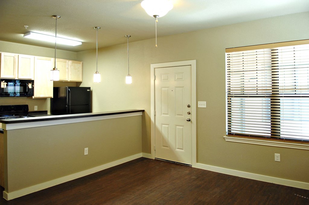 A kitchen area with a counter and cabinets at Centre Place Apartments, Denton, TX 76205