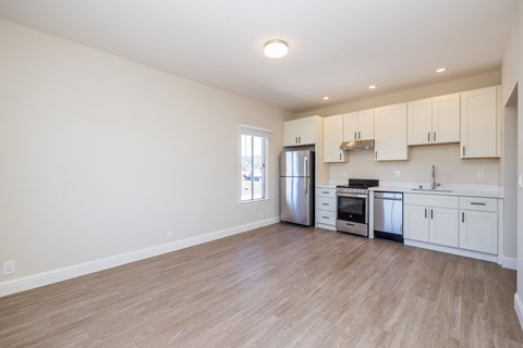 A kitchen with white cabinets and stainless steel appliances.