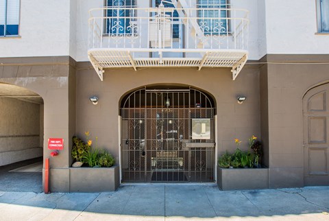 A building with a balcony and a gate.