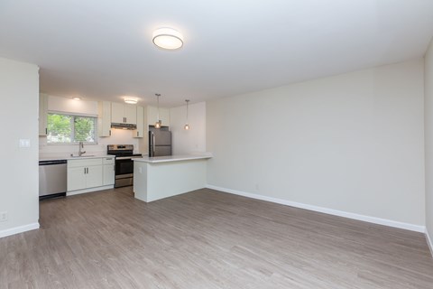 A kitchen with white cabinets and a refrigerator.