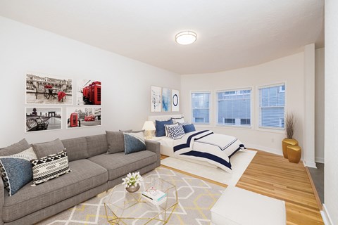 A living room with a grey couch and a coffee table.