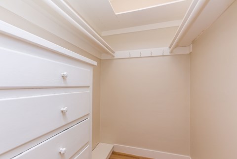 A white drawer is in a white cabinet.