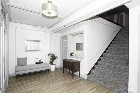 A living room with a grey couch and a wooden table.