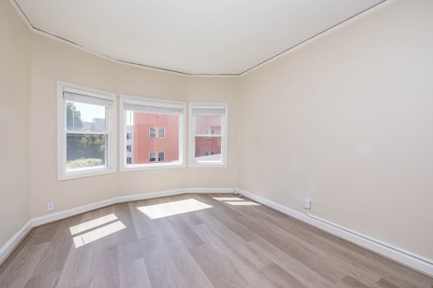 A room with a curved ceiling and wooden flooring.