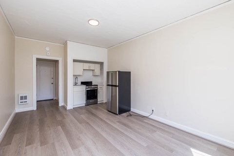 A kitchen with a black fridge and a white oven.