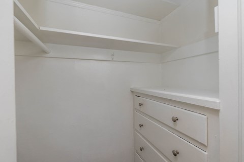 A white drawer is in a white cabinet.