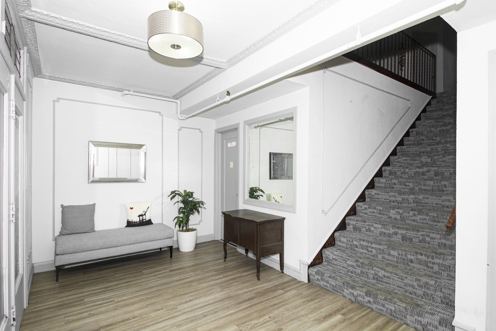 A living room with a grey couch and a wooden table.